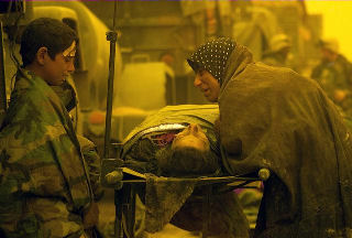 Displaced Iraqi civilians caught in a firefight north of An Nasiriyah, Iraq, grieve for a loved one, inside the Medical triage area of Regimental Combat Team 1 (RC T 1). Civilians are taken to RCT 1 to receive medical treatment for injuries. Location: AN NASIRIYAH, IRAQ Date Shot: 26 MAR 2003 Camera Operator: CPL MACE M. GRATZ, USMC