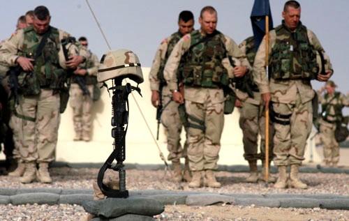 Soldiers of 1st Brigade, 101st Airborne Division (Air Assault), mourn the loss of Capt. Christopher Seifert at a memorial ceremony, Monday at Camp Pennsylvania. Seifert was killed when a grenade was thrown into a sleep tent early Sunday morning. The attack left 15 other soldiers wounded.