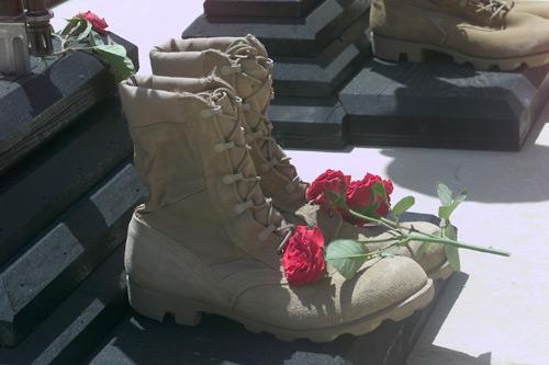 Three roses lie on the boots of Staff Sgt. Justin Galewski, an EOD (explosive ordnance disposal) soldier who was killed, along with three other service members, April 15, when rockets they were attempting to destroy accidentally exploded. Galewski was a native of Olathe, Kan. The soldiers' personal effects were displayed during a memorial service April 18 at Kandahar Airfield, Afghanistan. (U.S. Army photo by Spc. Elizabeth Casebeer, 314th Press Camp Headquarters)