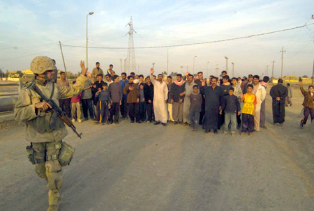 A U.S. Marine says goodbye after meeting Iraqi citizens from the city of Al Fay.  U.S. Marine Corps Photo Cpl. Mace M. Gratz